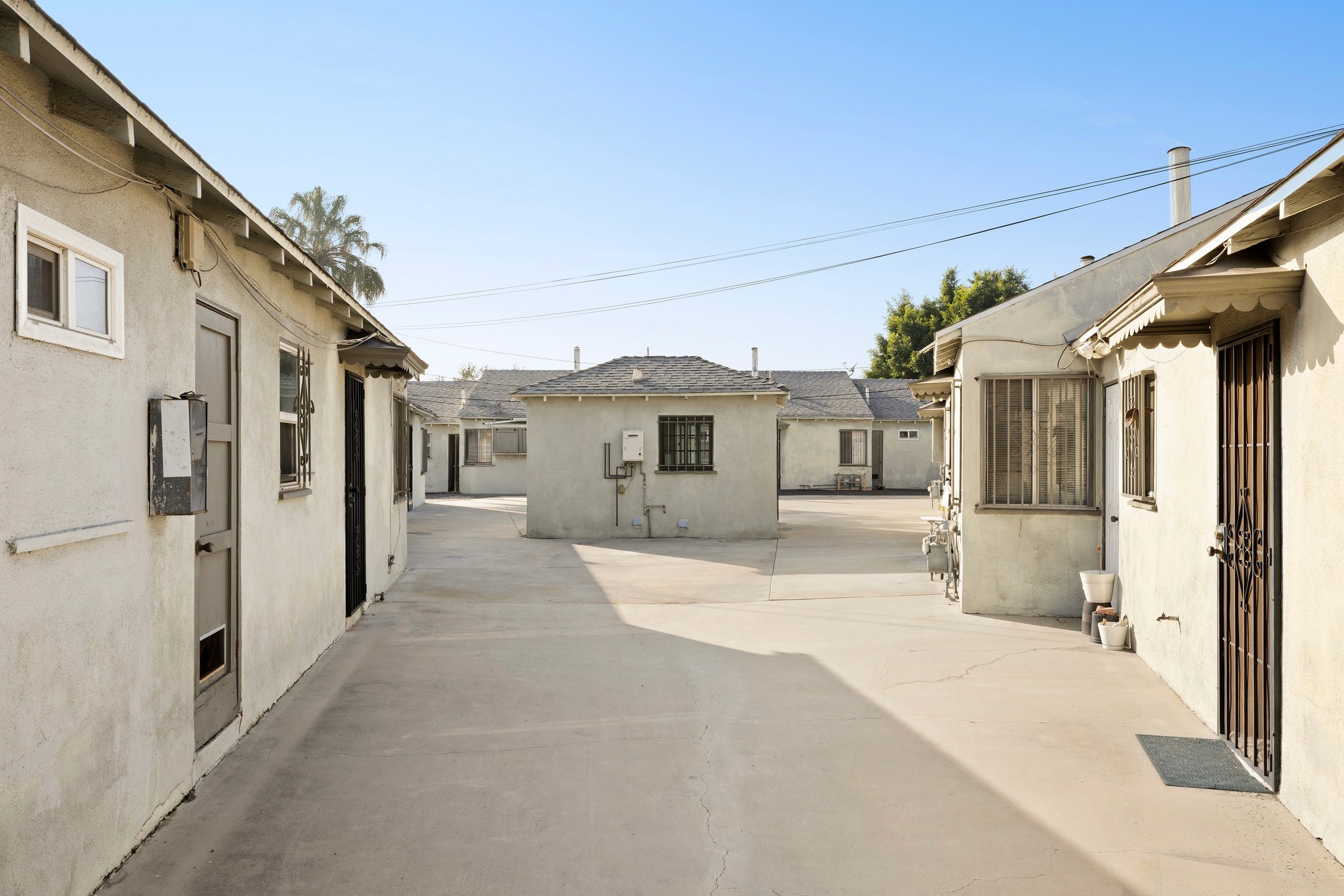 Concrete driveway and unit entrances at 1105 E Hyde Park showcasing low-density layout.