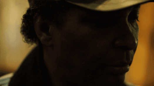 moody close portrait of a man with a baseball hat