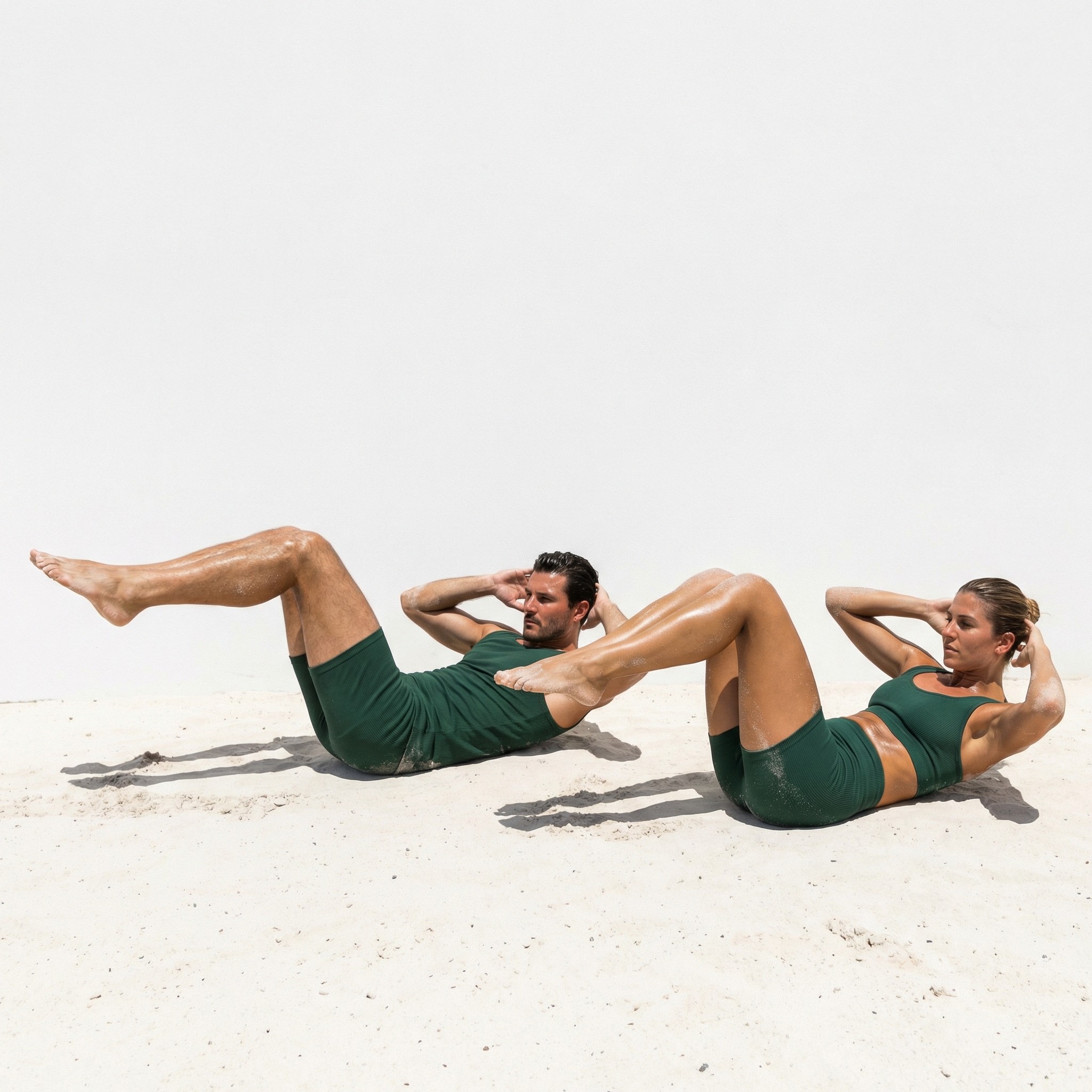 Man and woman performing synchronized core crunches, highlighting the inclusive, gender-neutral approach to small-group fitness at MokoBoko Lisbon