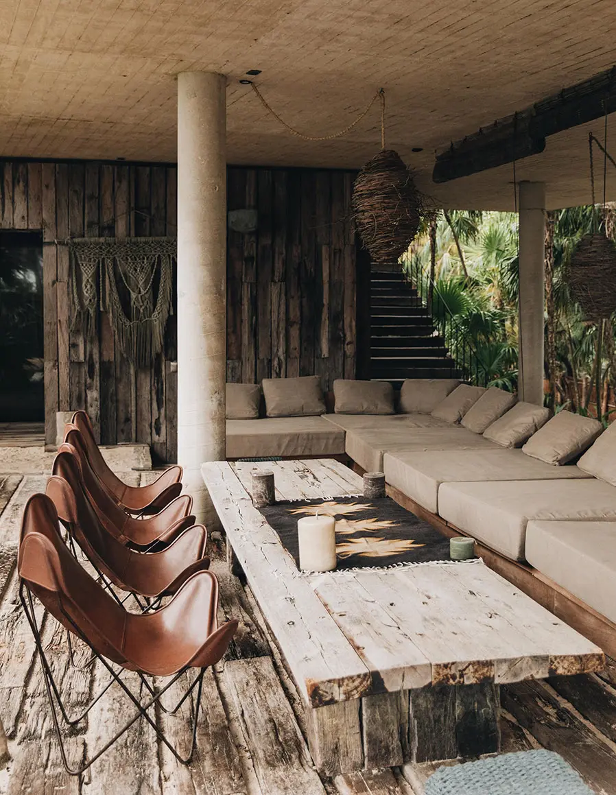 Relaxing seating area at Casa Sastran with extra sofas, hanging lamps, and ceiling fans.