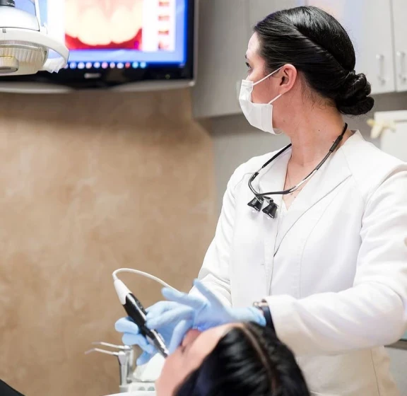 Dentist examining a patient with an intraoral camera