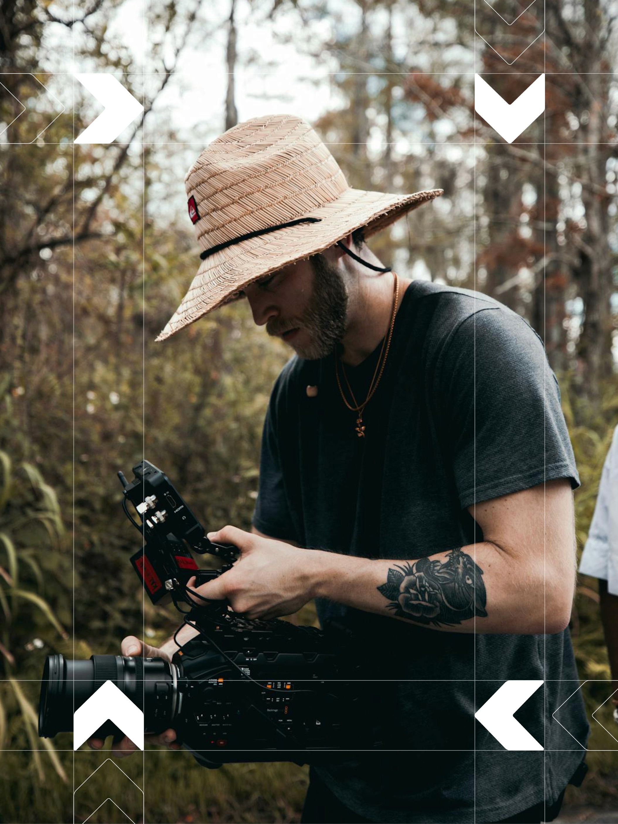 Modern home office setup with a monitor, ergonomic chair, keyboard, and indoor plants near a window with blinds.