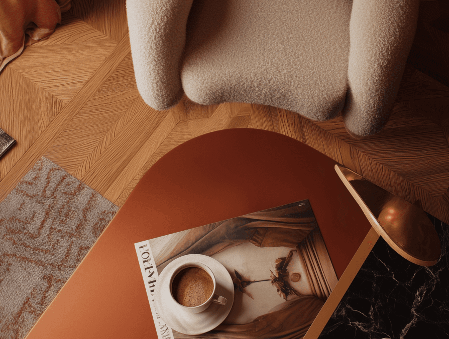 A coffee table with a magazine on it beside a chair in a cozy living room setting.