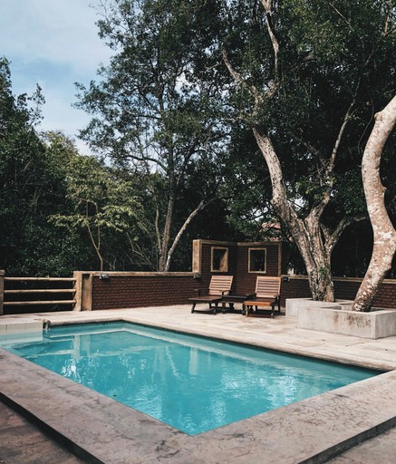two lounge chairs near swimming pool illustrating house buying