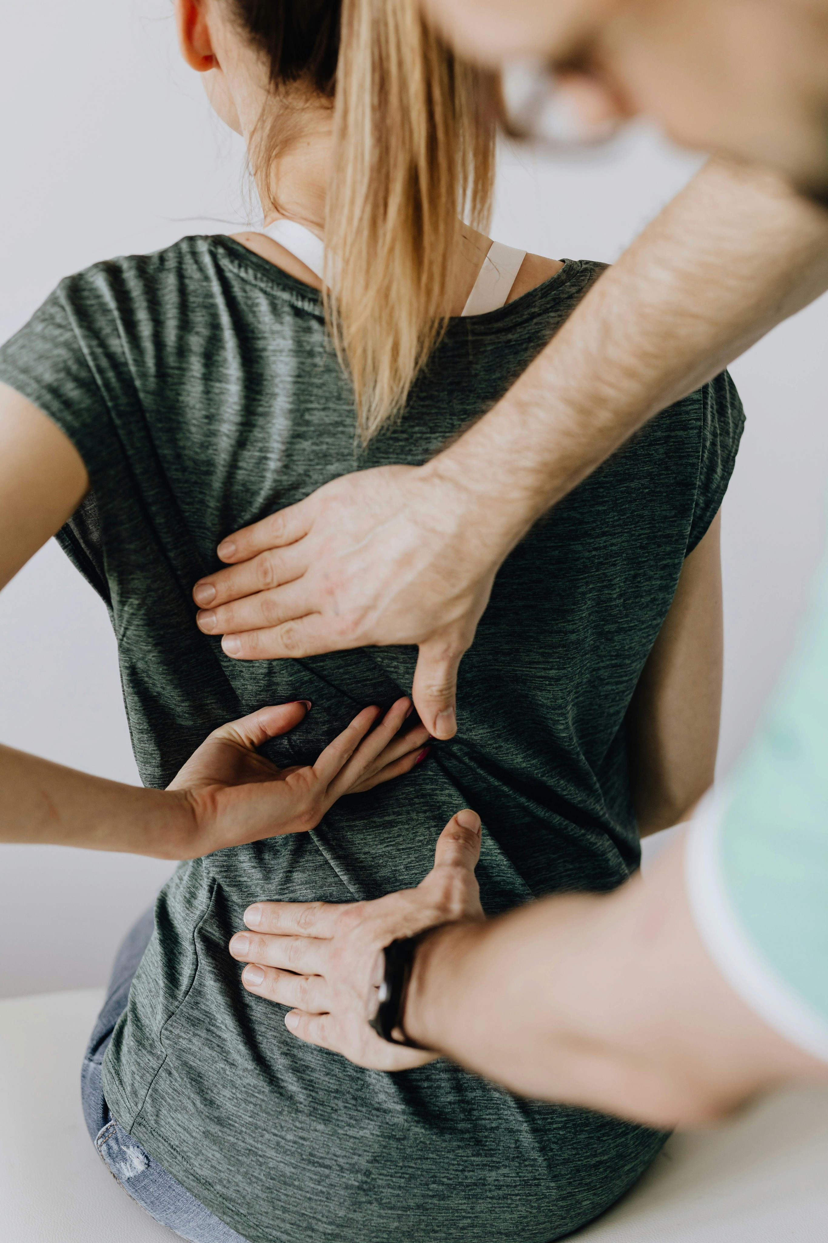 A chiropractor helping his patient