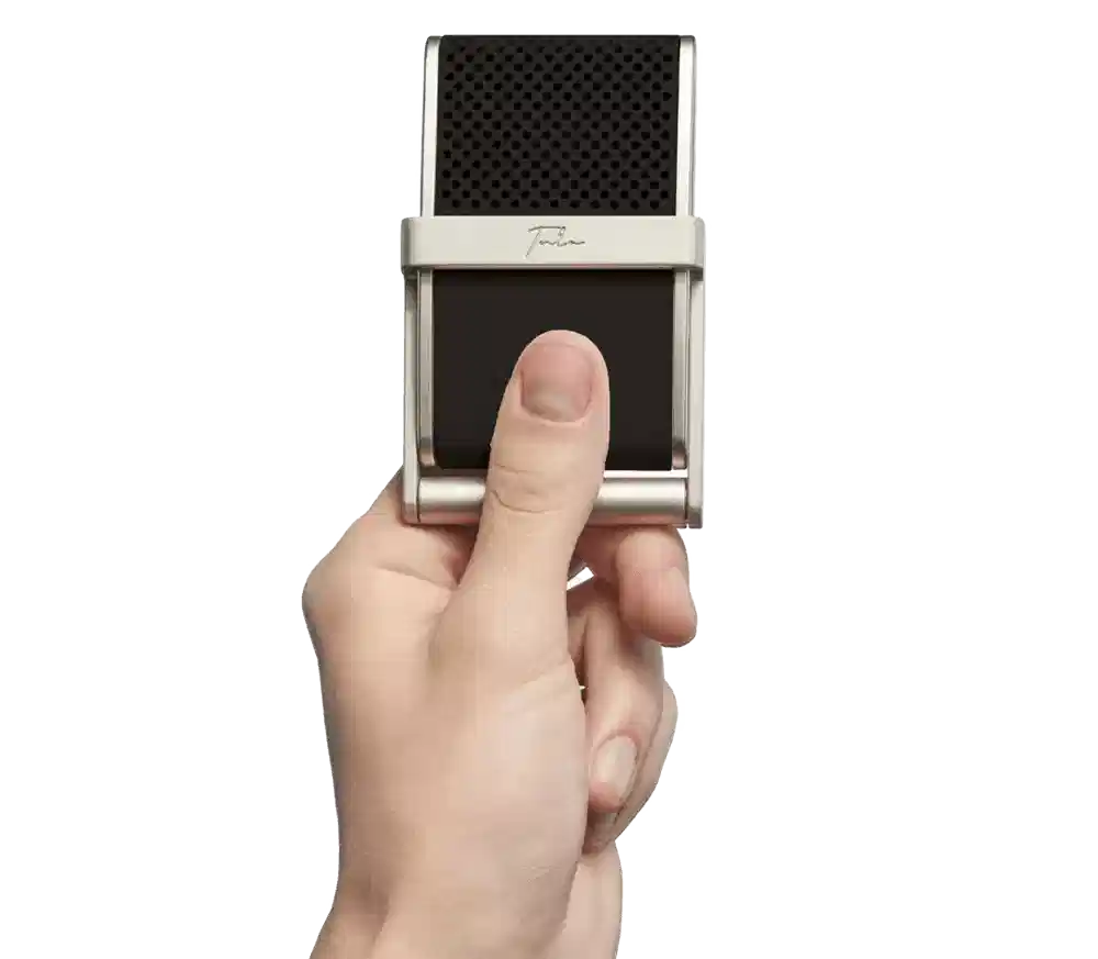 A stylish individual in a black shirt and silver pants stands against a blurred background, creating a dynamic and modern aesthetic.