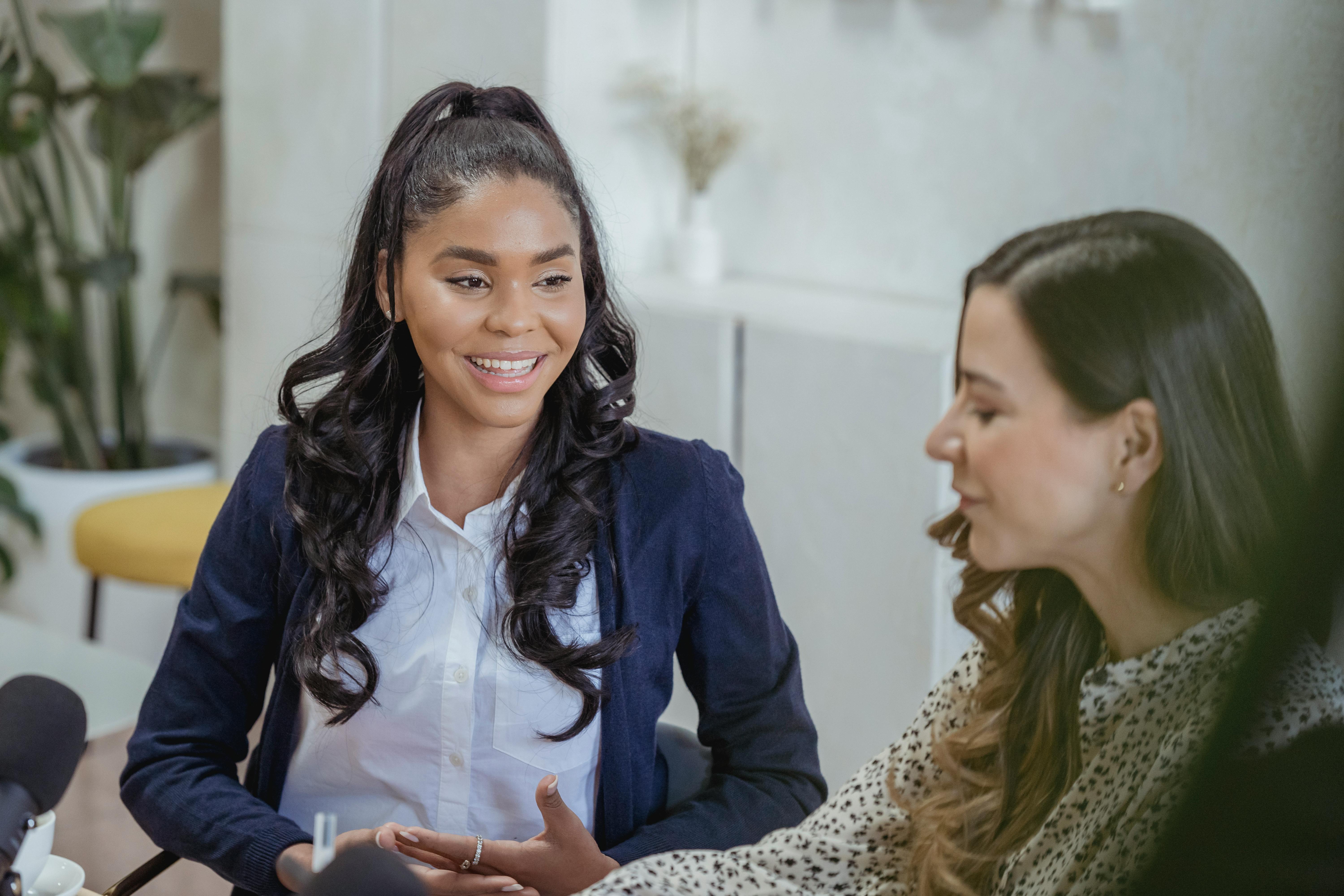 Two women sat talking