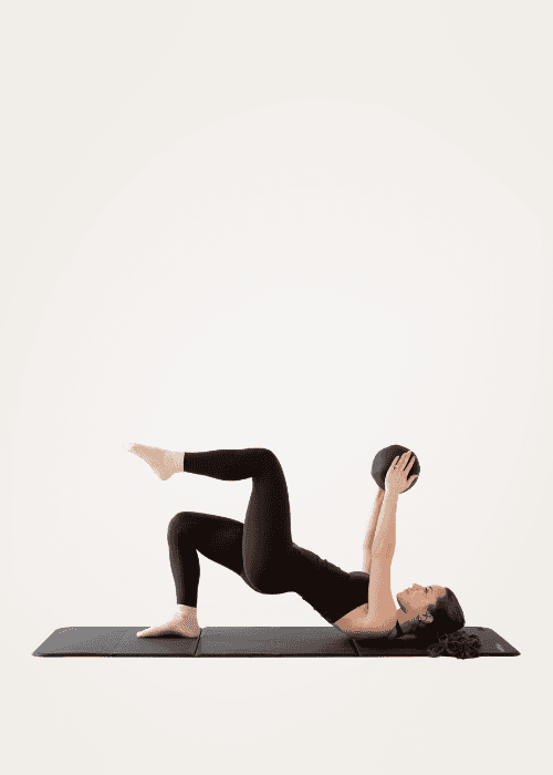 Woman doing a bridge exercise during mat Pilates