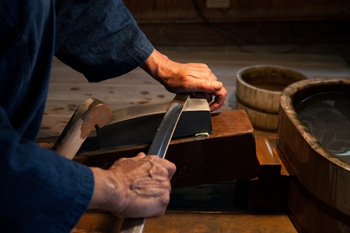 Swordsmith polishing a blade