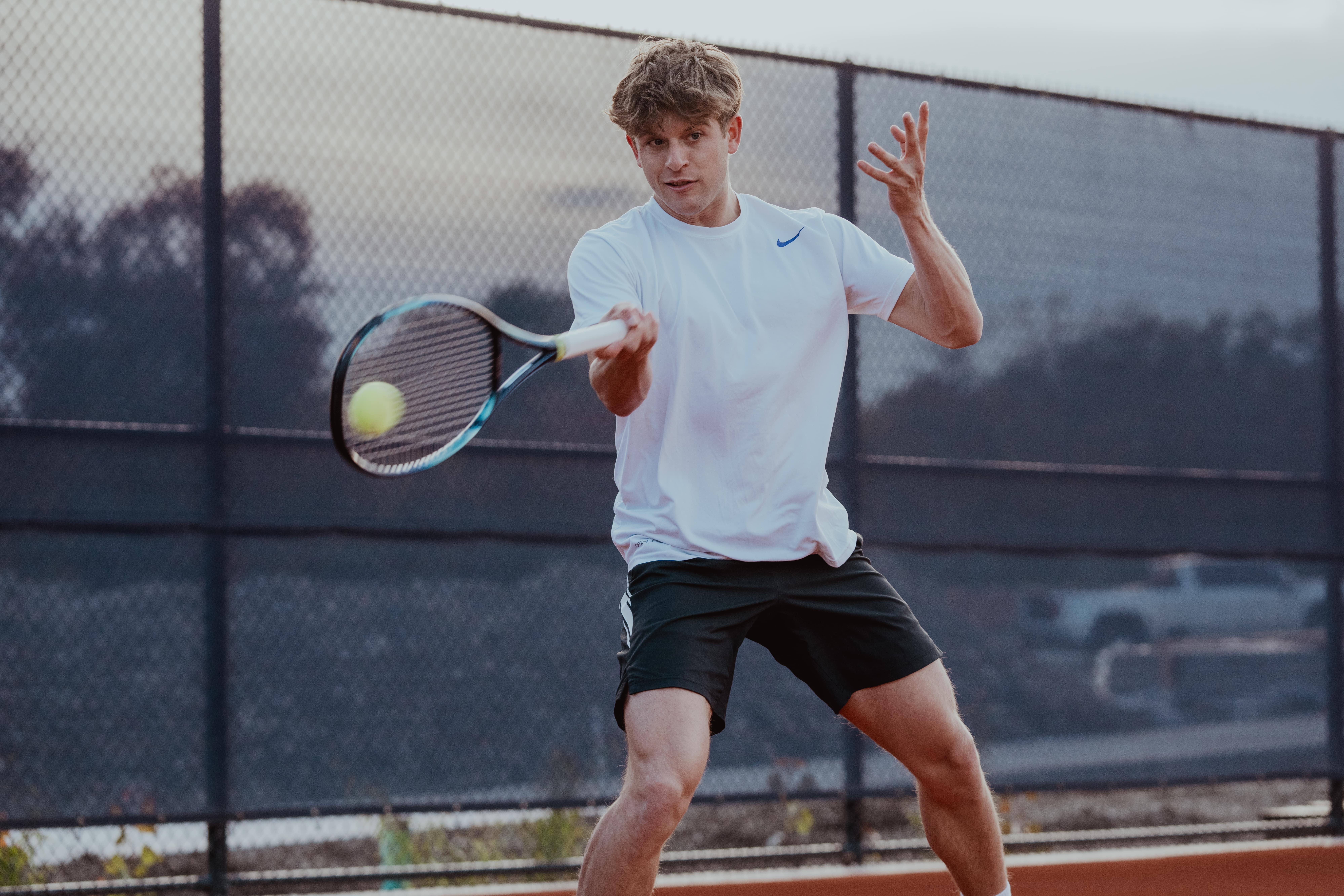 person playing tennis - Sports That Require Flexibility 