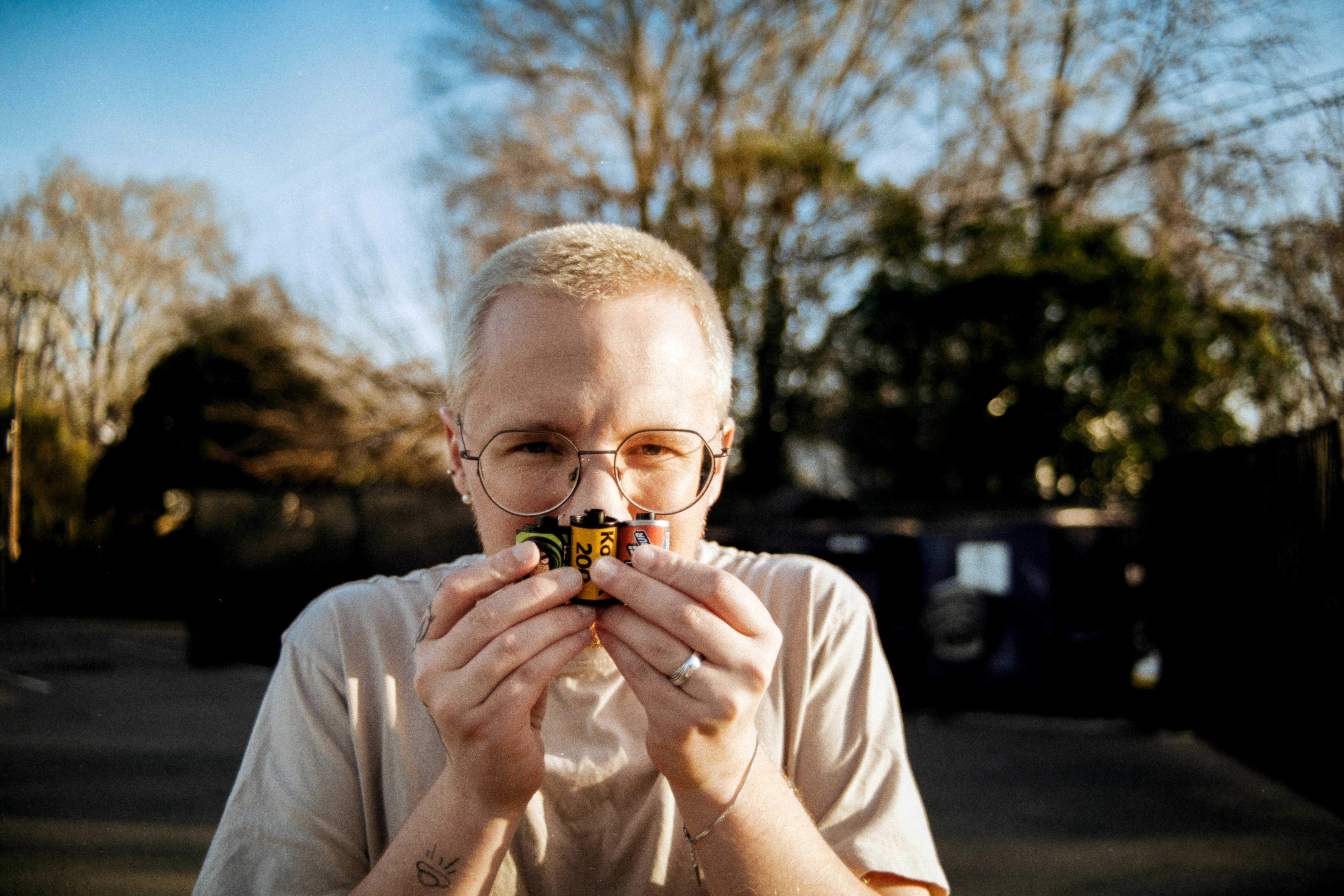 Man smelling a small toy car outdoors