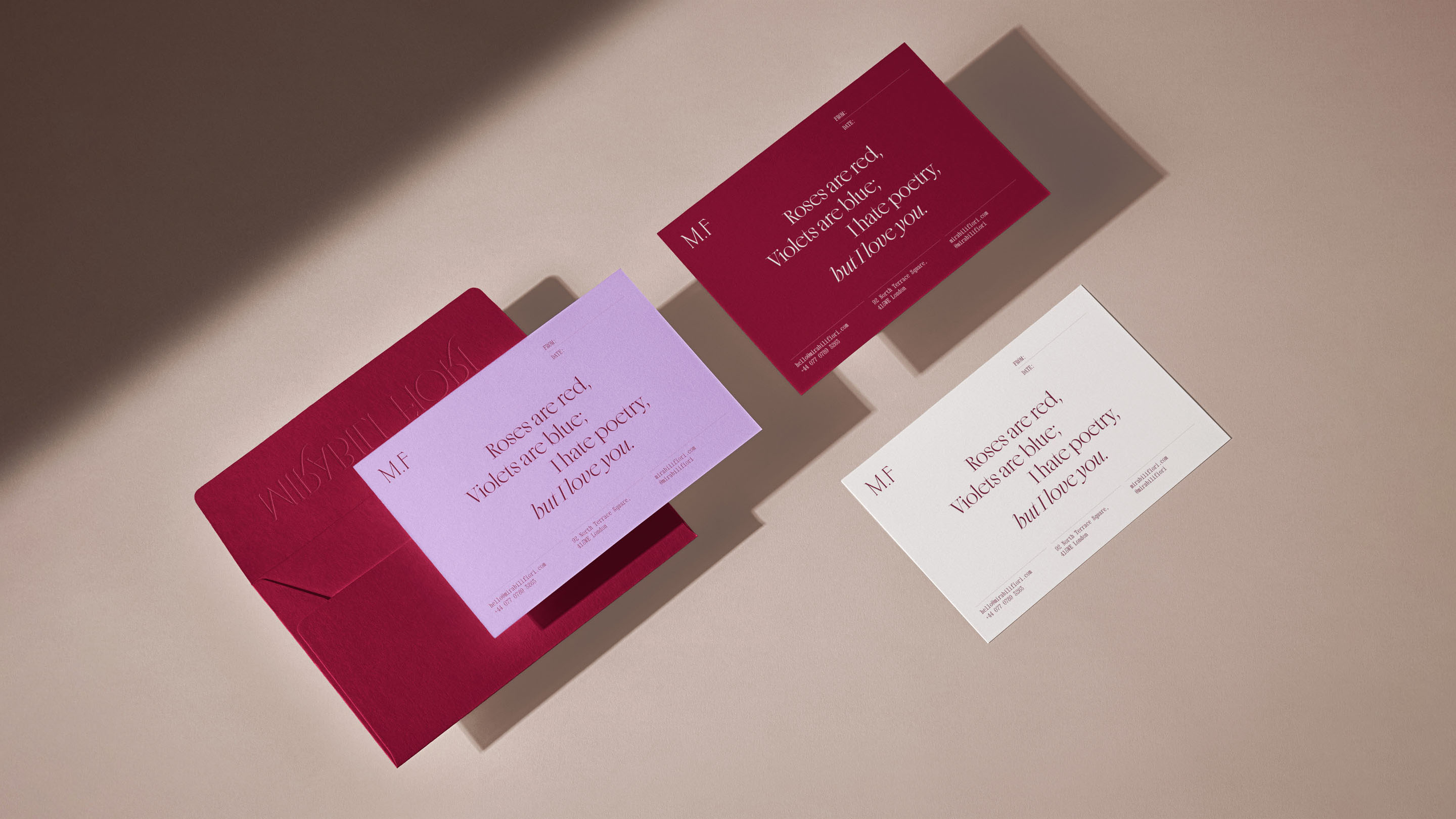 Stationery suite with notecards and an envelope in burgundy, lavender, and cream with poetry text