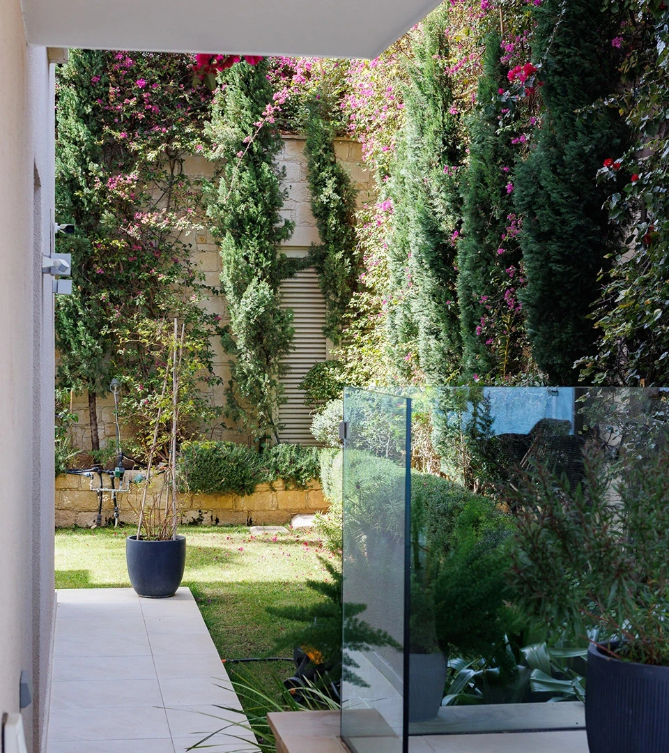 Seafront Residence Limassol secluded garden patio with climbing greenery, layered planting, and glass windscreen