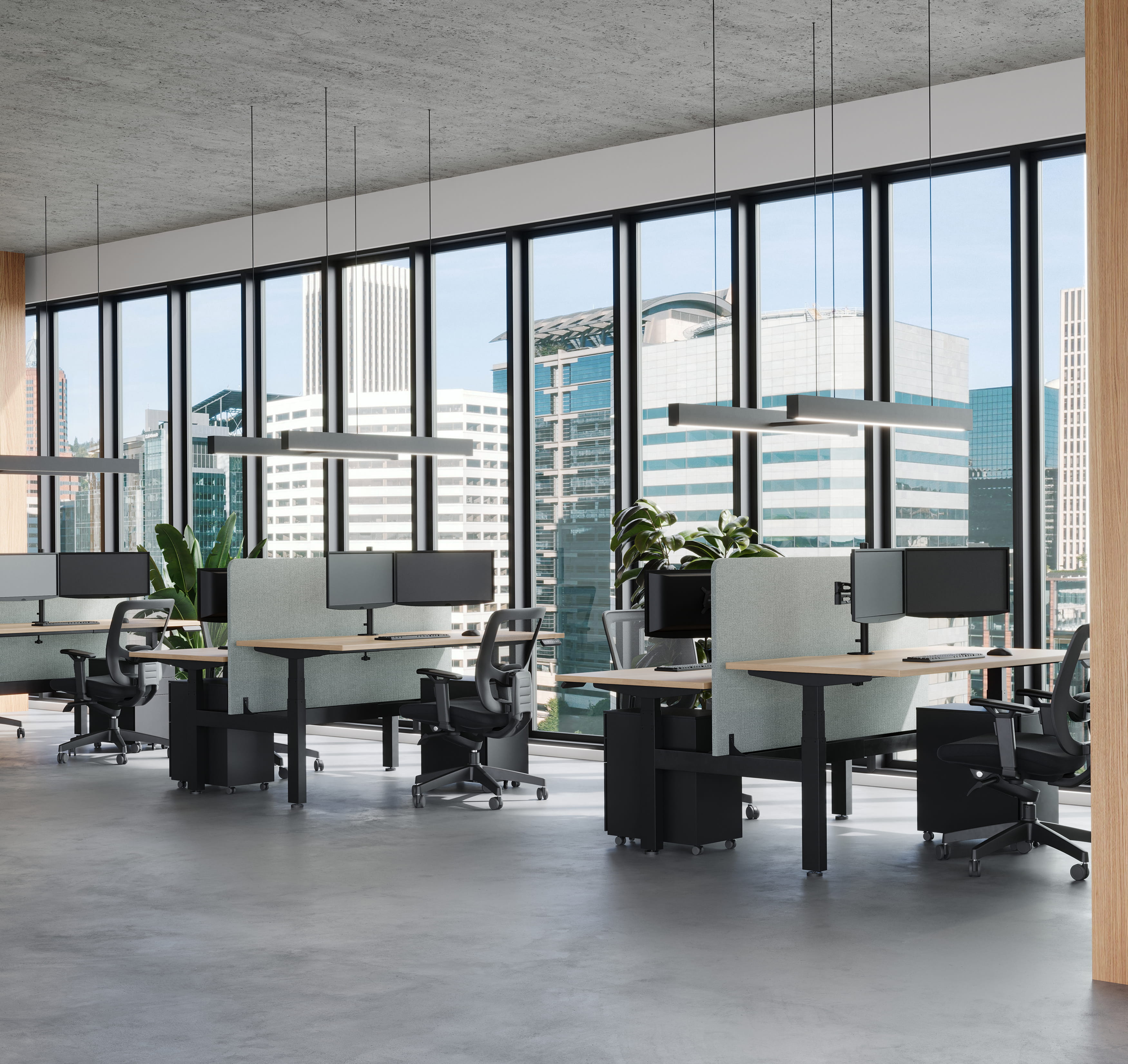 Open office workspace with desks, chairs, and large windows with city view