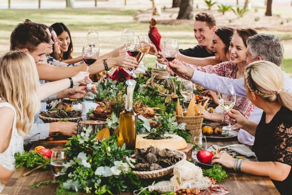 Guests cheering over a Xmas Lunch outside
