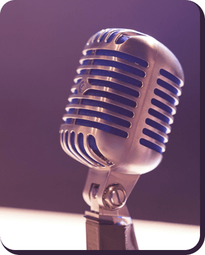 Old-school silver microphone on purple background.