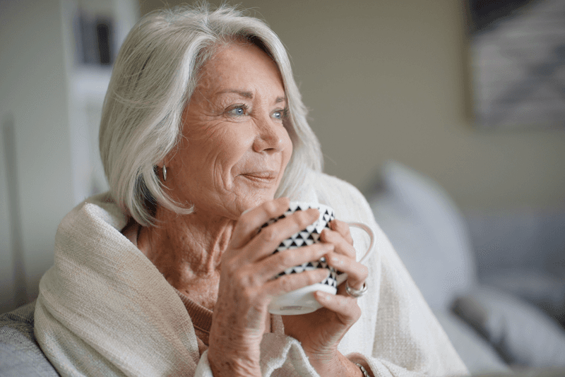 Elderly woman drinking coffee
