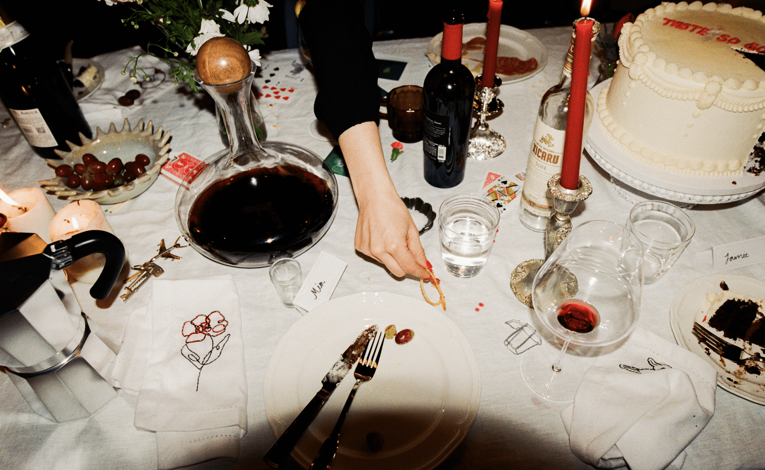A decorative floral arrangement spills over a table draped in red fabric, creating an elegant atmosphere.