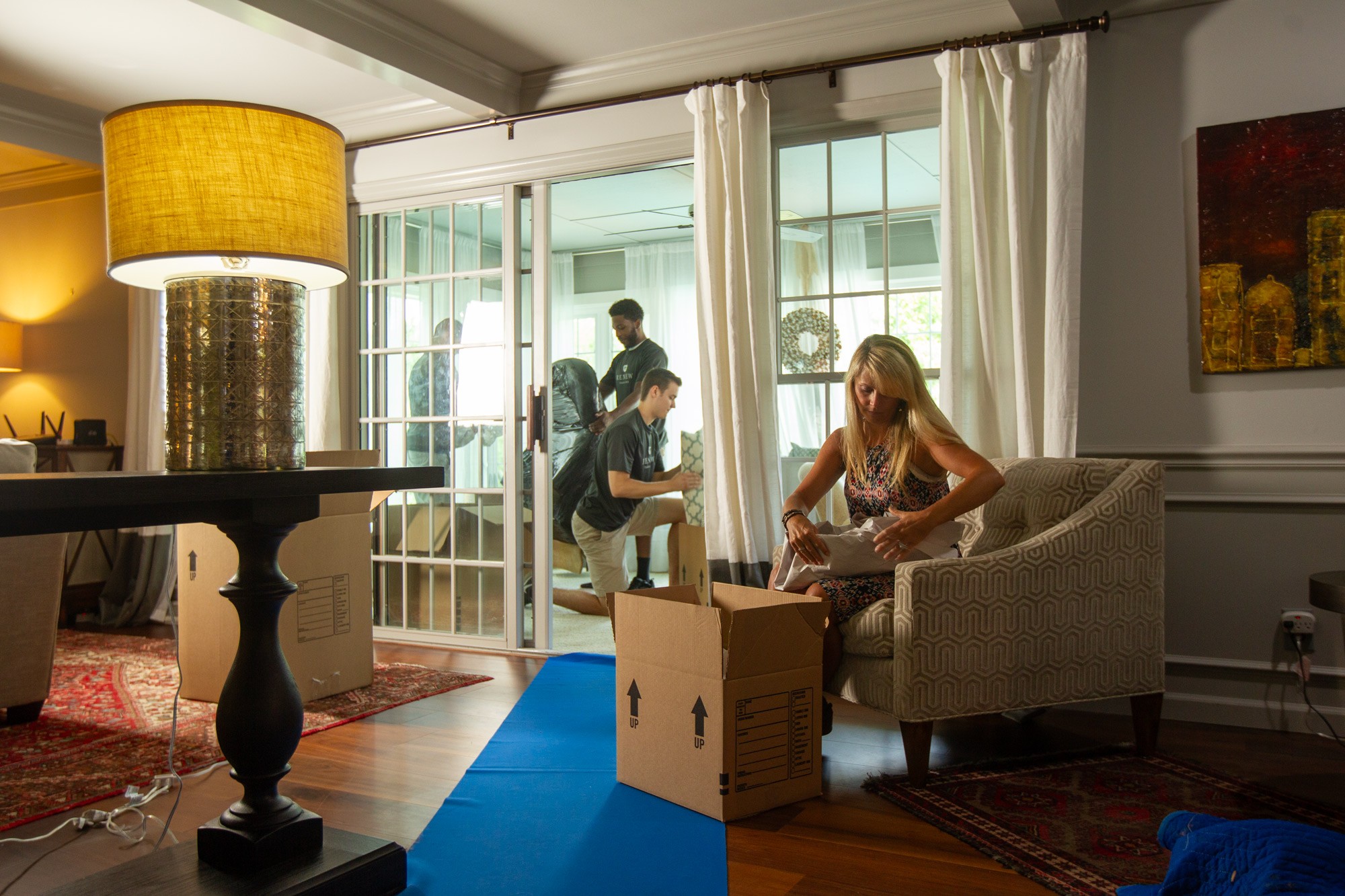 Professional packers meticulously wrapping and securing fragile items for move