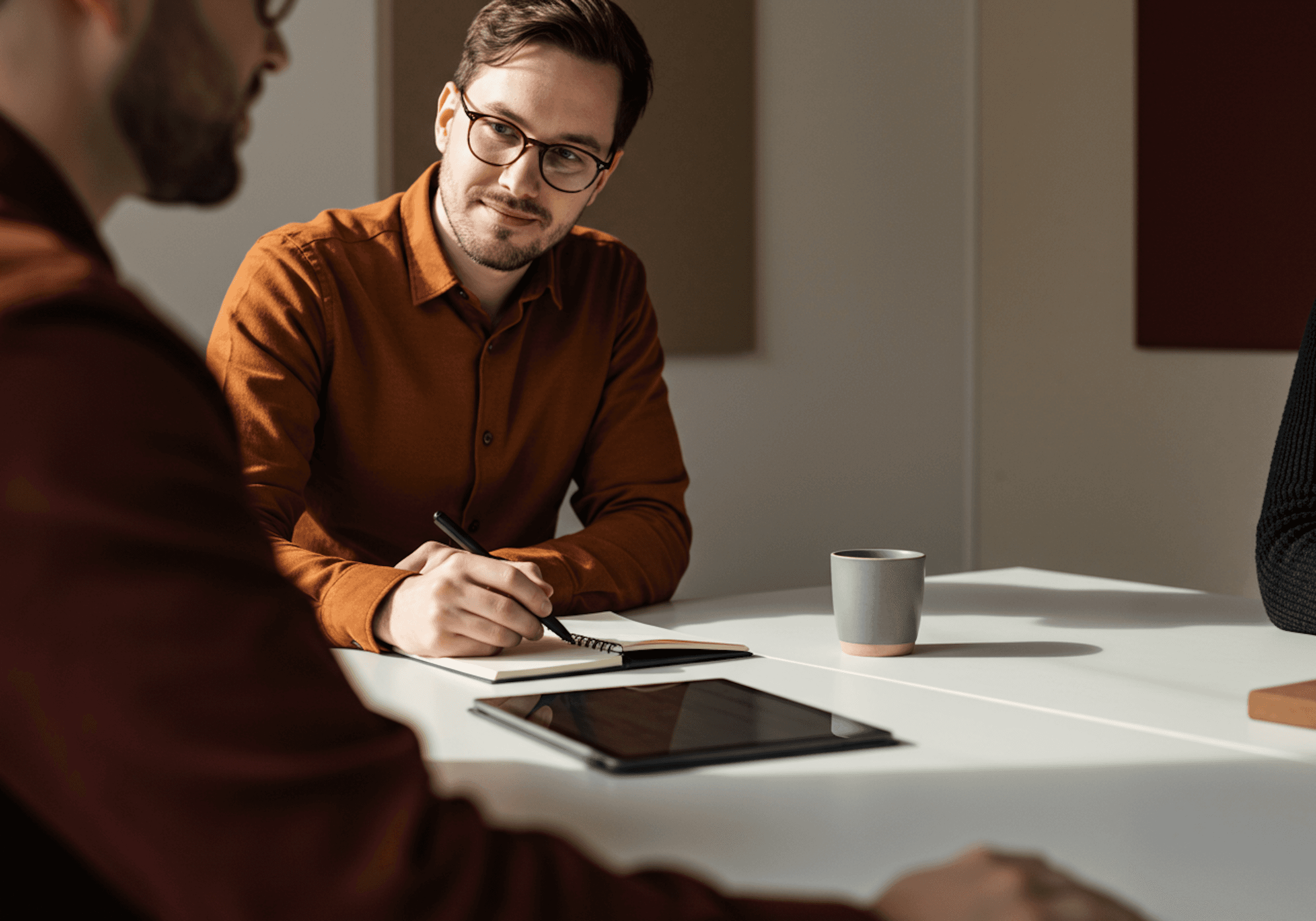 Two men are sitting at a table.