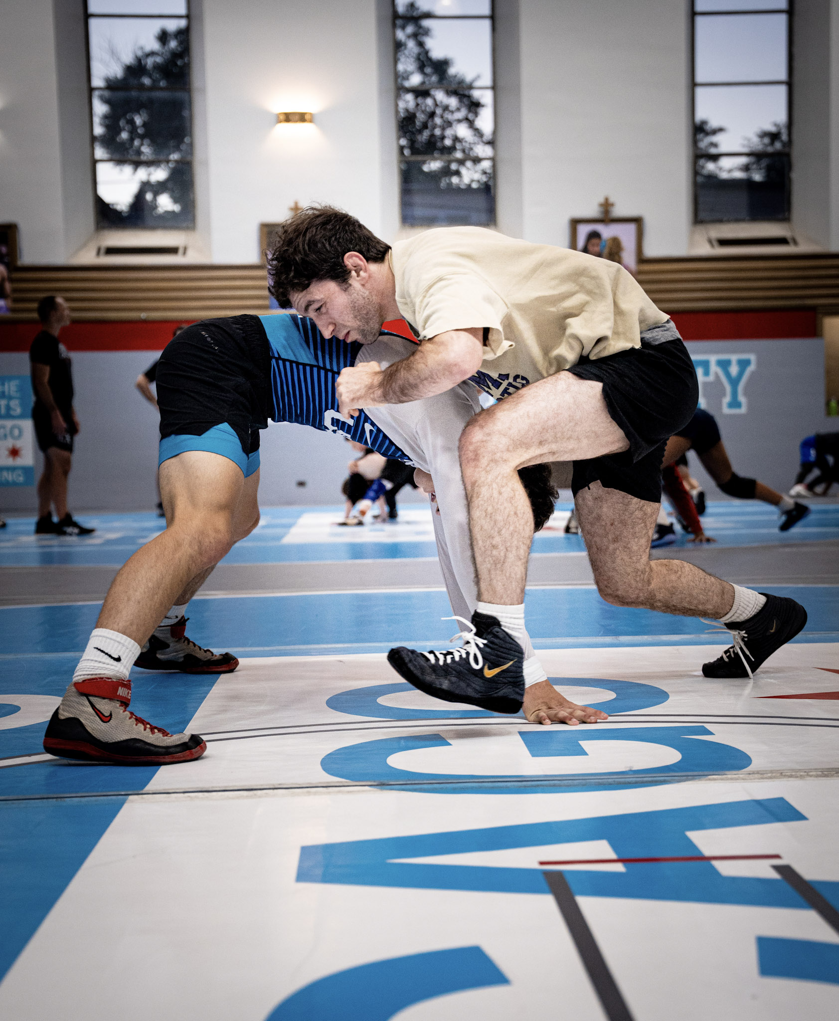 Ben Rosen drilling a takedown with a wrestler at practice.