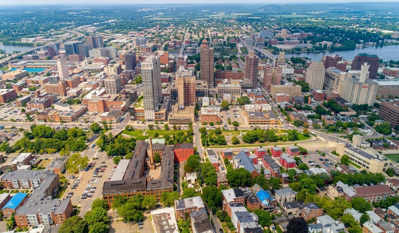 aerial view of a medium sized city center with buildings and neighborhoods in view.