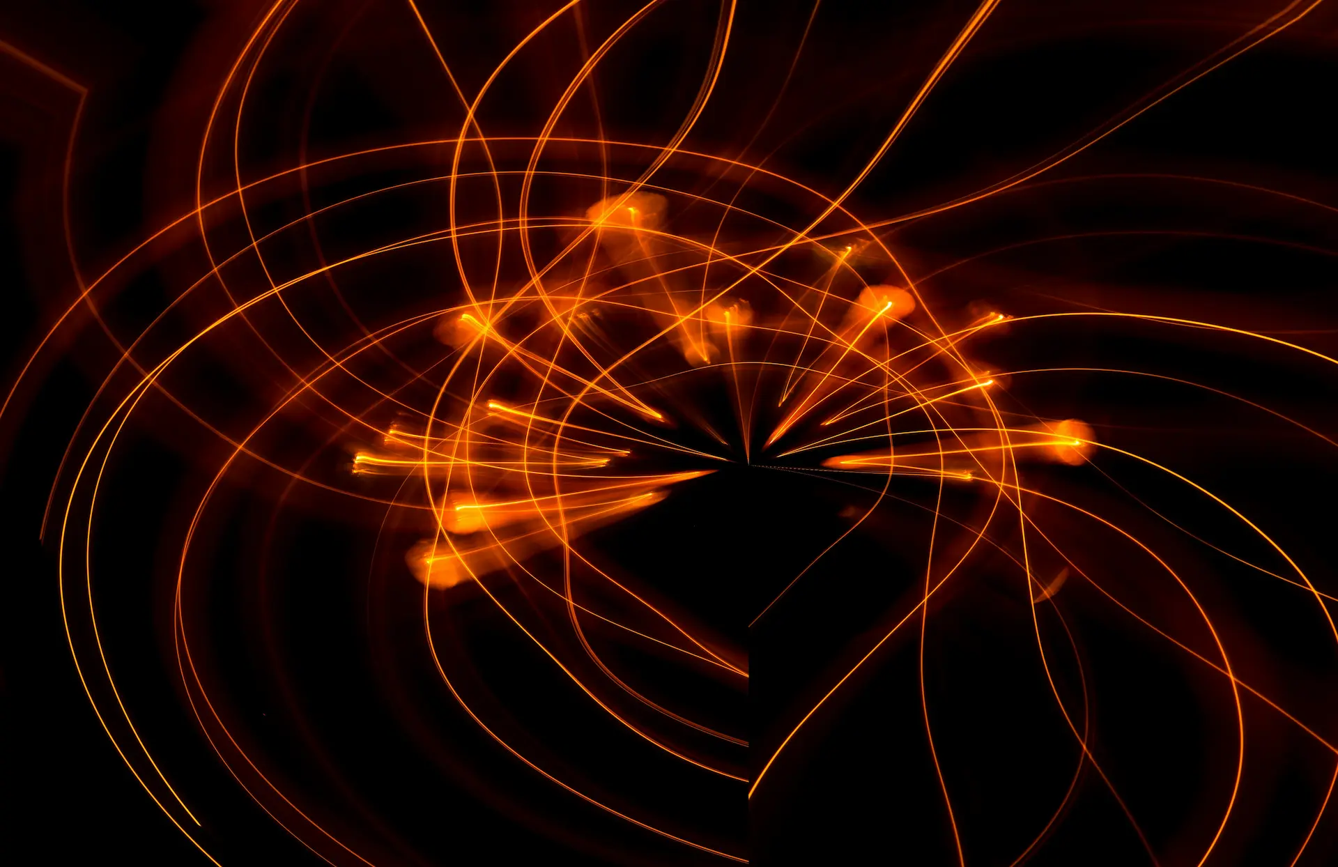 Abstract network of glowing orange light trails converging and radiating from a central point against a dark background