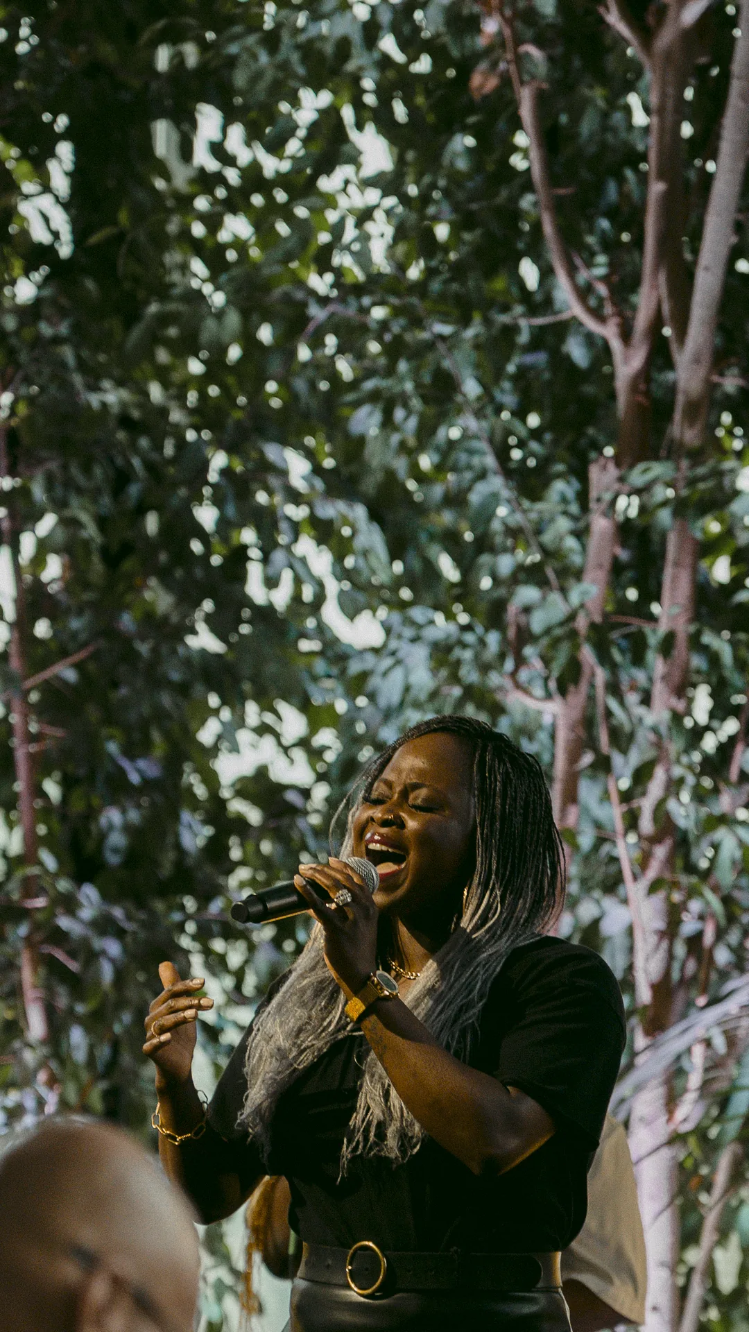 Worship team leading passionate Spirit-filled worship surrounded by trees during a Sunday service at Elan Church in Naperville, IL