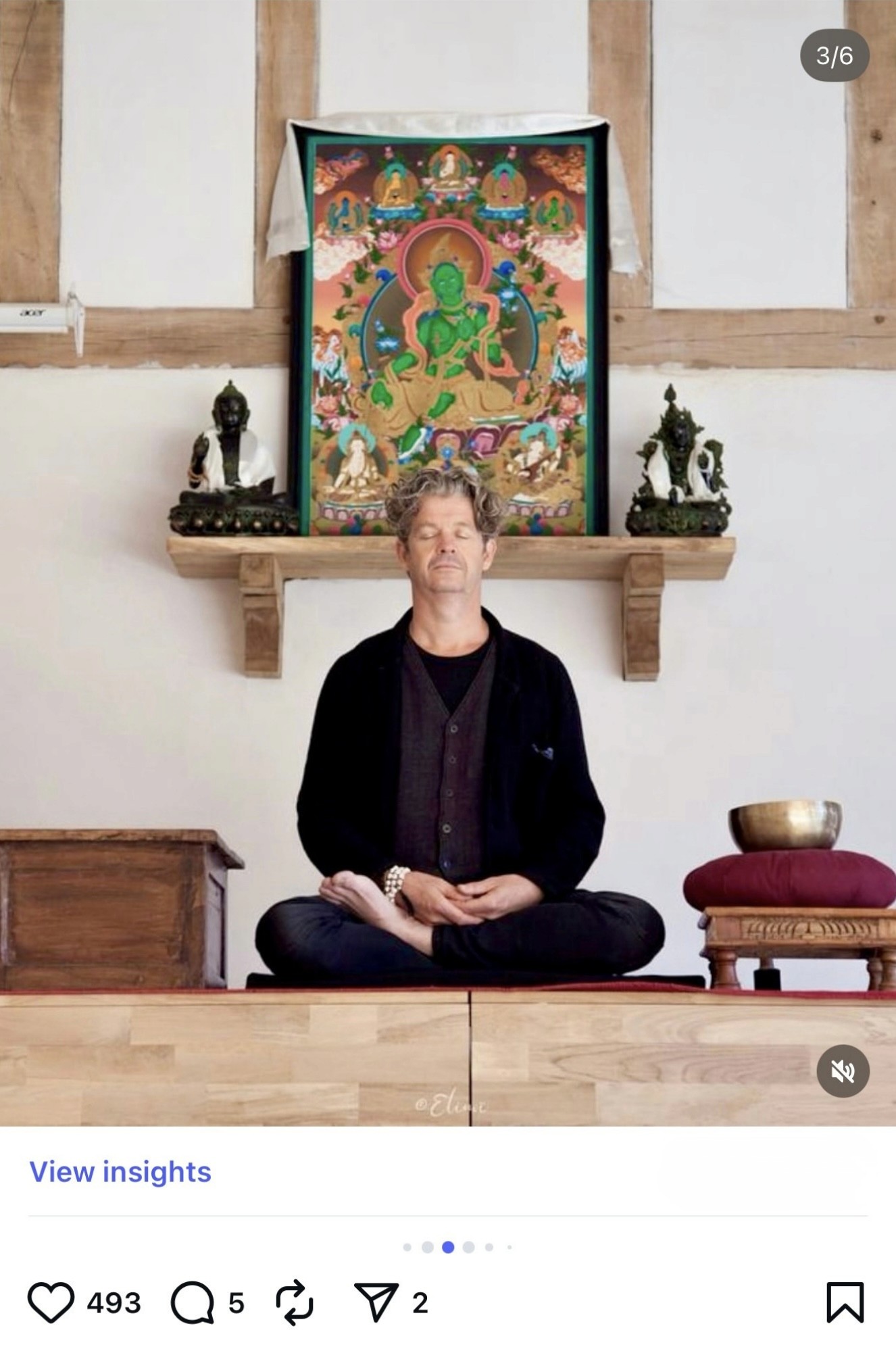 A toothbrush with a soft bristle head positioned against a black background.