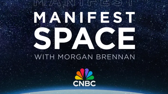 Geoscientist Graham Lederer uses a hand lens to examine tungsten ore