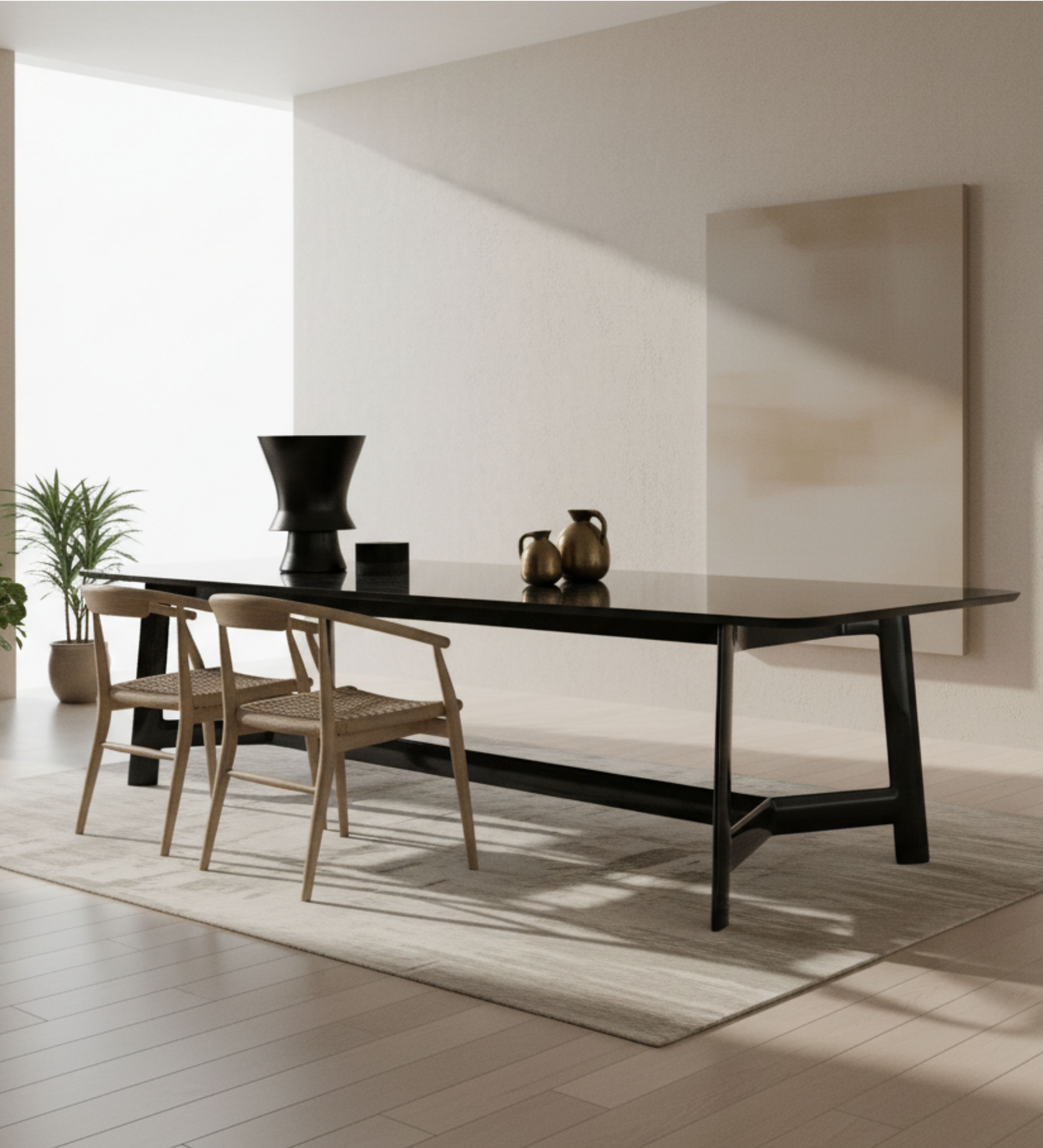 Minimal black dining table with slim profile, paired with woven wooden chairs