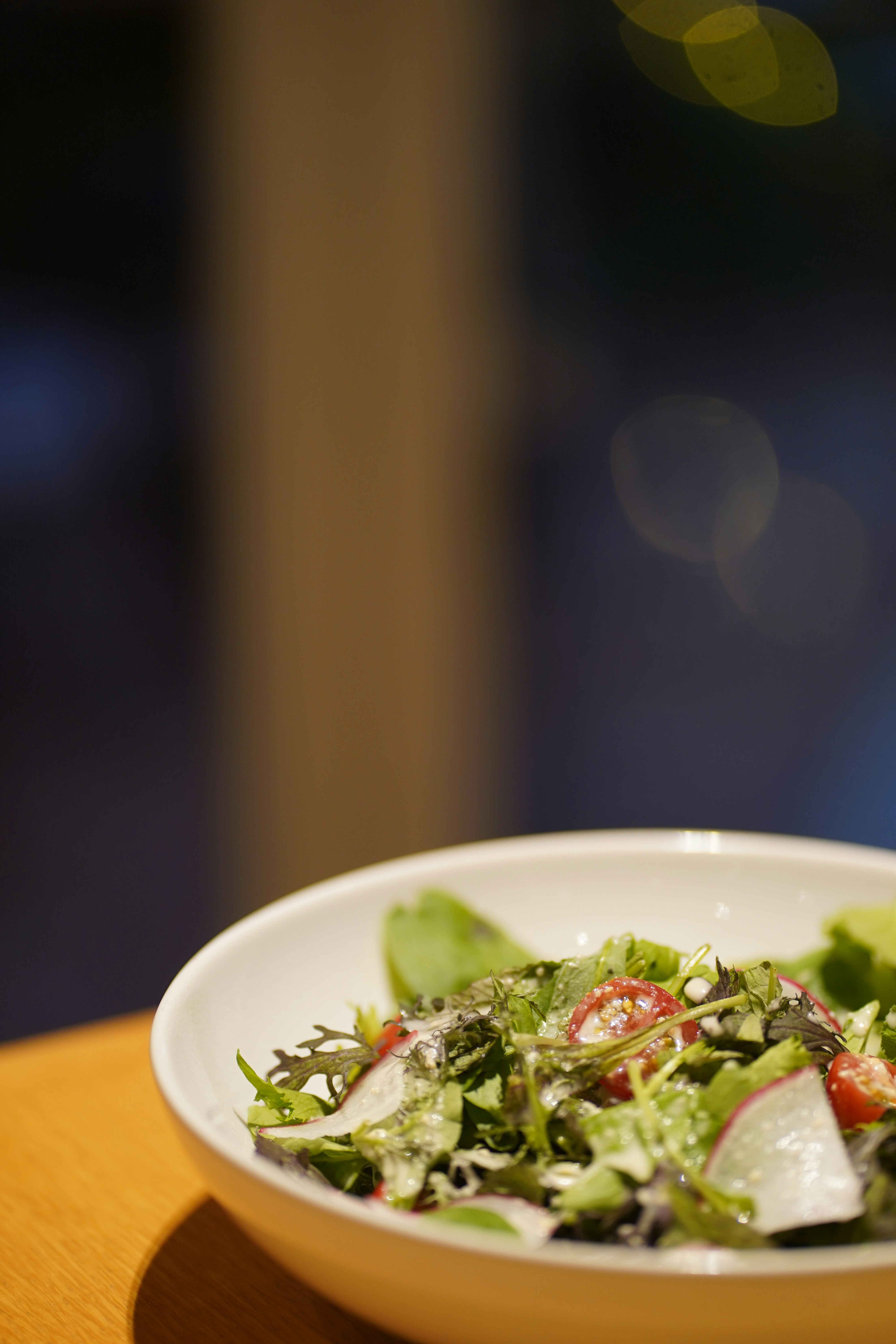 A fresh salad in a white bowl.