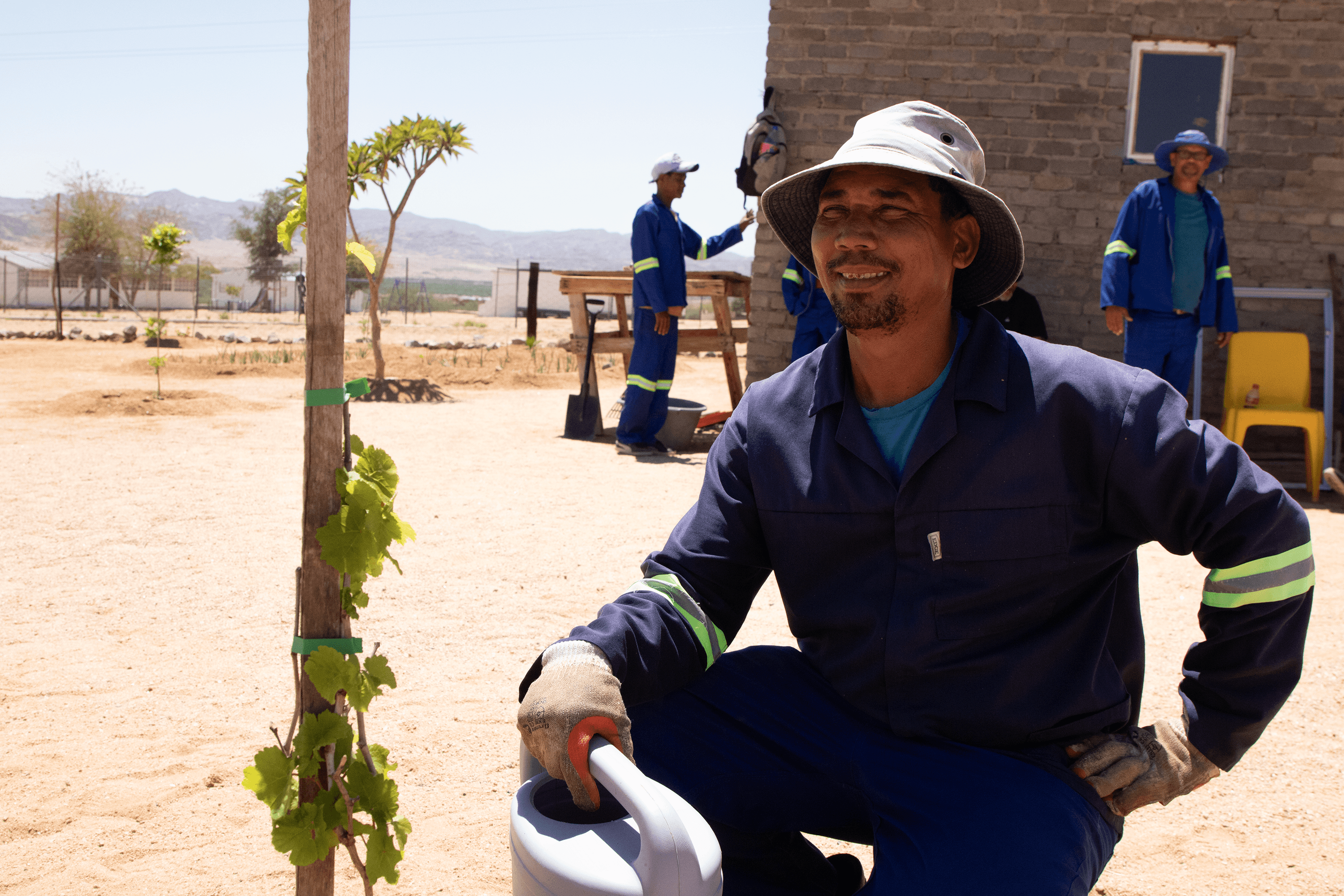 Community team member caring for a newly planted tree.
