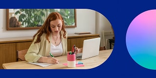 Woman sitting with a laptop, checking off items on an accessibility checklist.