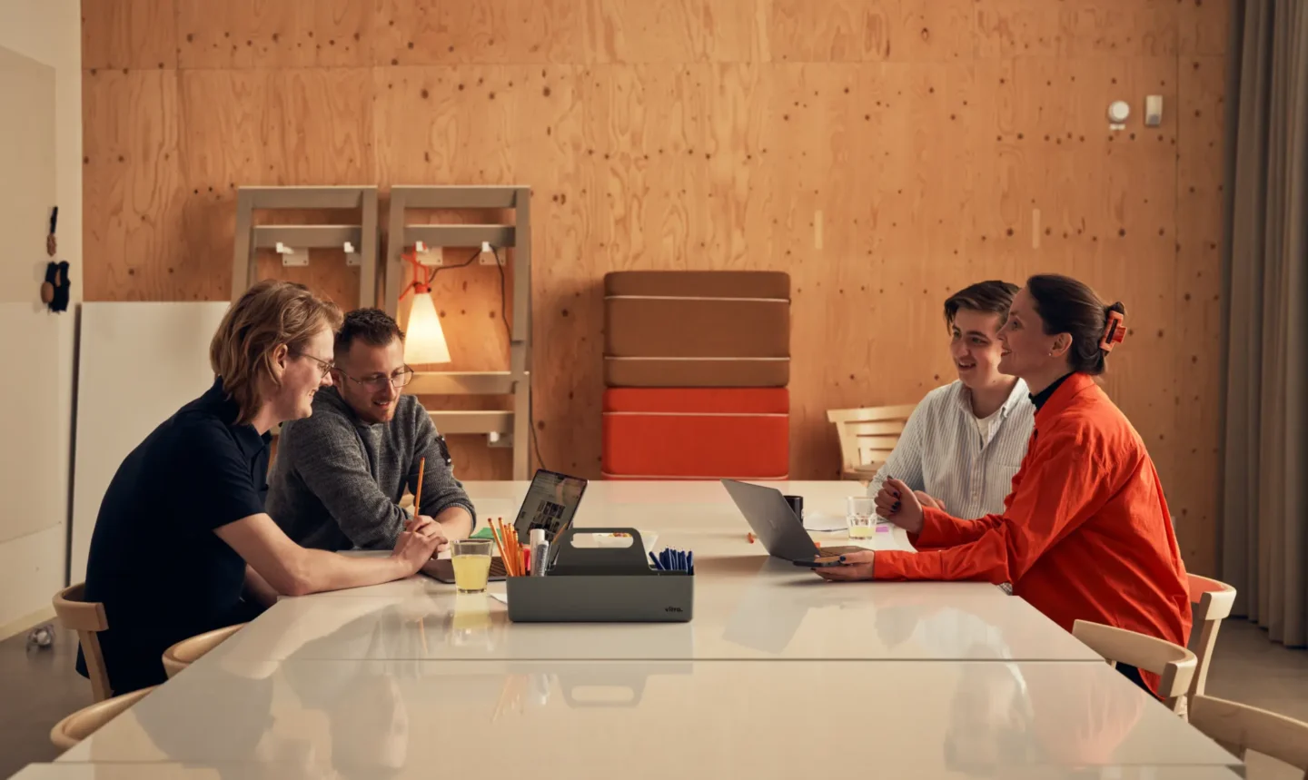 Four people working in a conference room