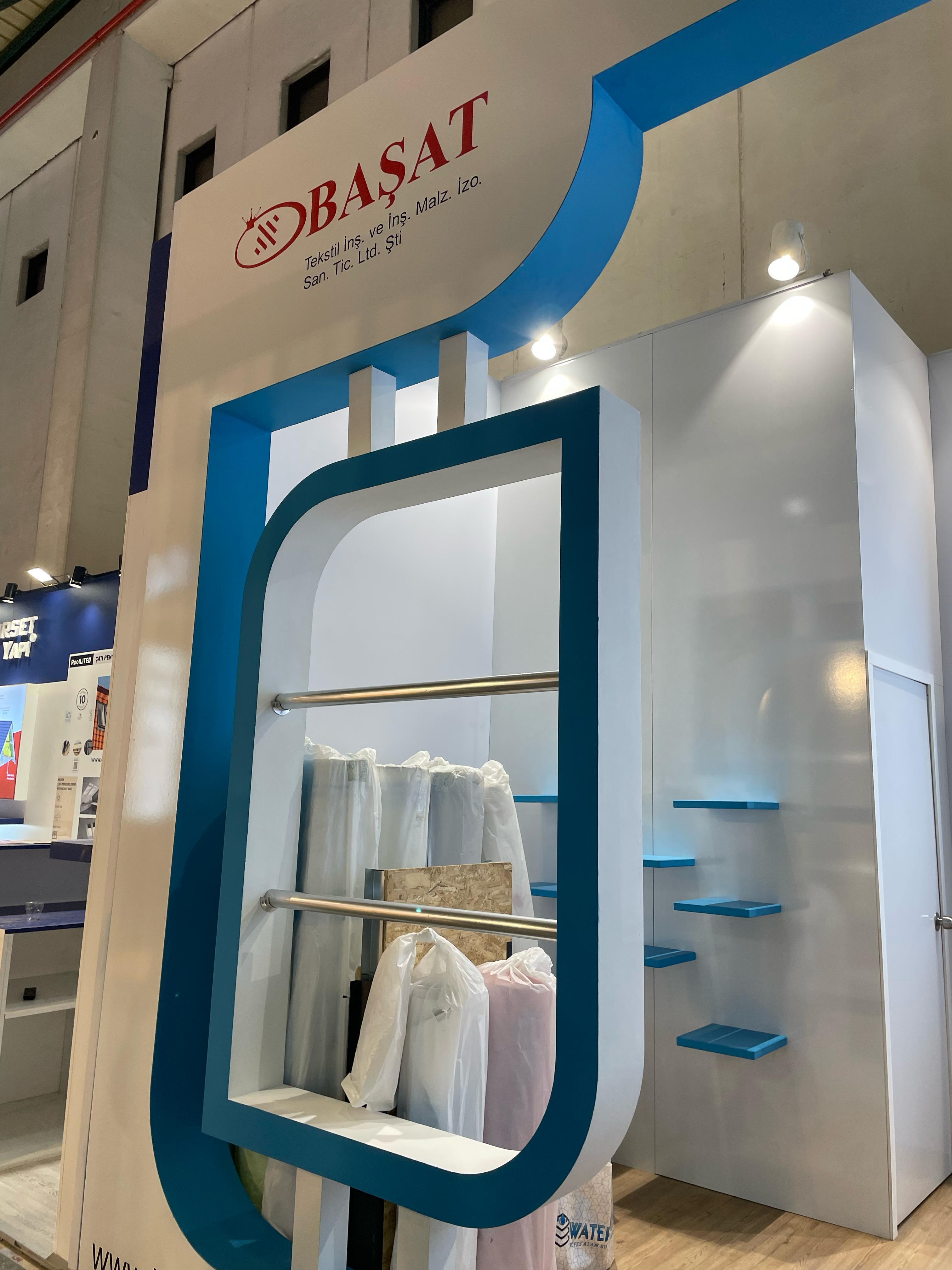 Large curved blue frame at the Başat Watershield stand, creating a soft and fluid appearance that connects to the theme of water protection and waterproofing.