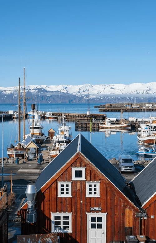 Suburban house with a two-car garage at twilight after a rain shower.
