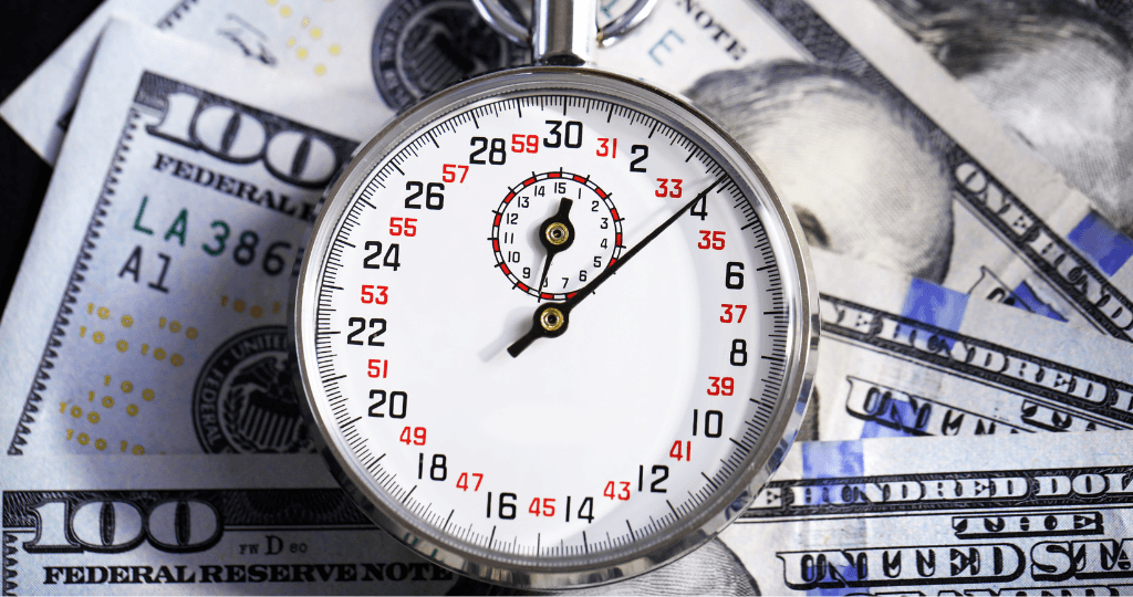 Stopwatch on dollar bills, symbolizing time and money efficiency