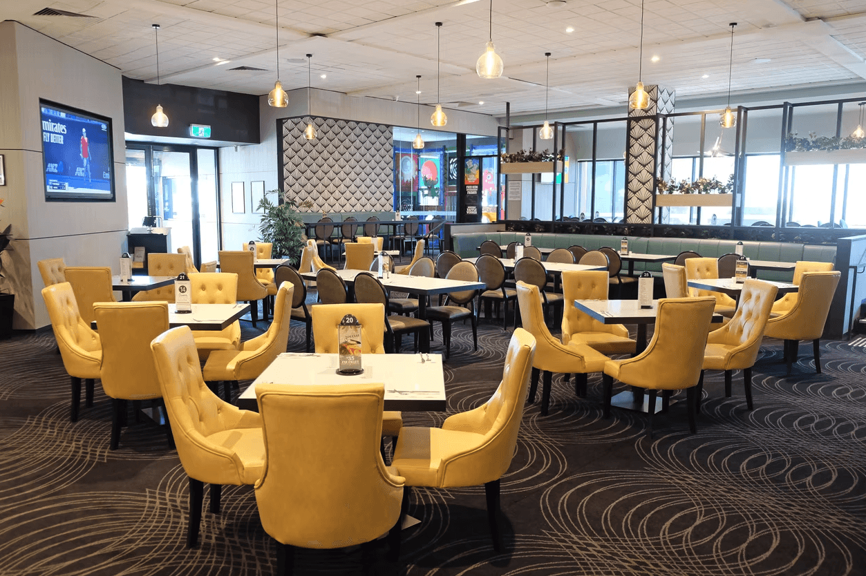 brown wooden chairs and table near glass window