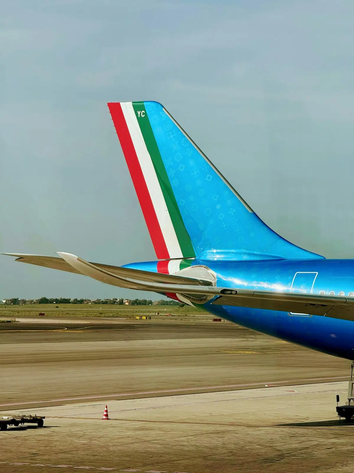 An ITA AIRWAYS sitting on top of an airport tarmac in Milano Malpensa