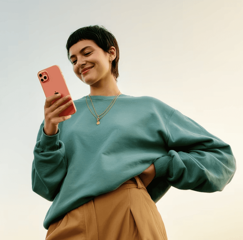 stylish individuals outdoors, enjoying their smartphones under a clear sky, showcasing vibrant outfits and modern Stylish individual outdoors, enjoying her smartphone under a clear sky, showcasing vibrant outfits and modern tech.