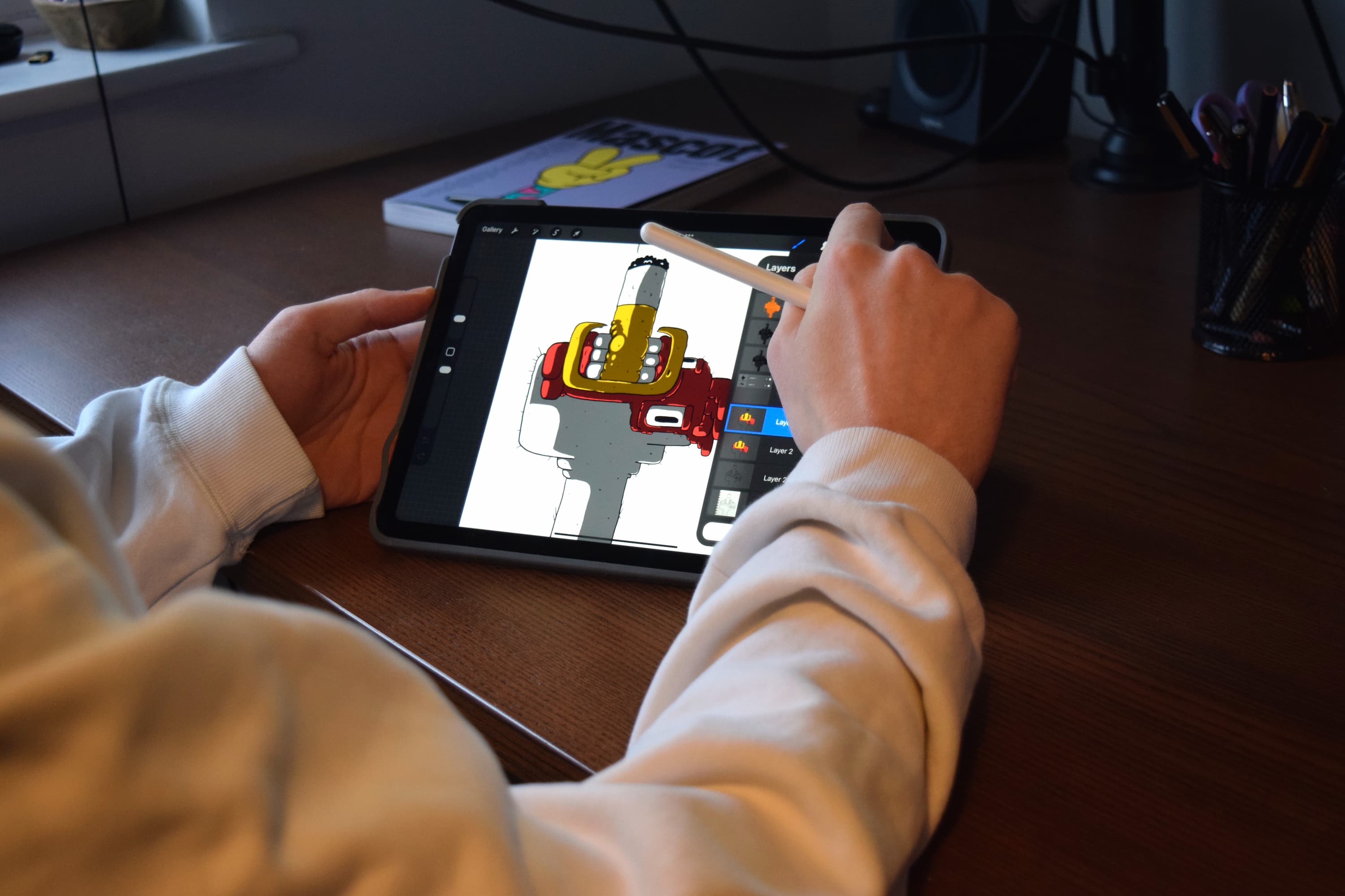 Image of designer illustrating a chicken smoking a cigarette on drawing tablet.