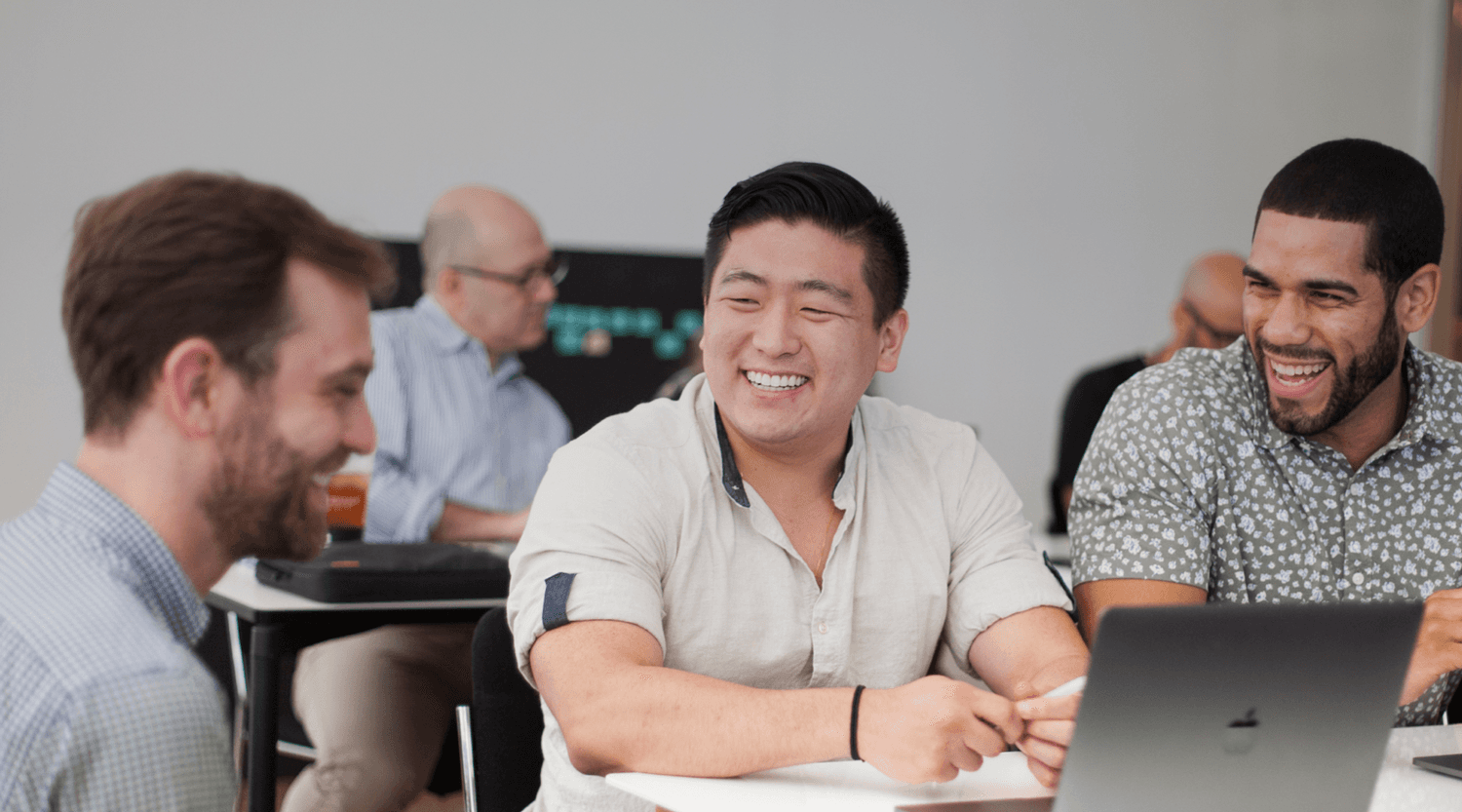A learner in a design studio, engaged and seated at a laptop during a session.