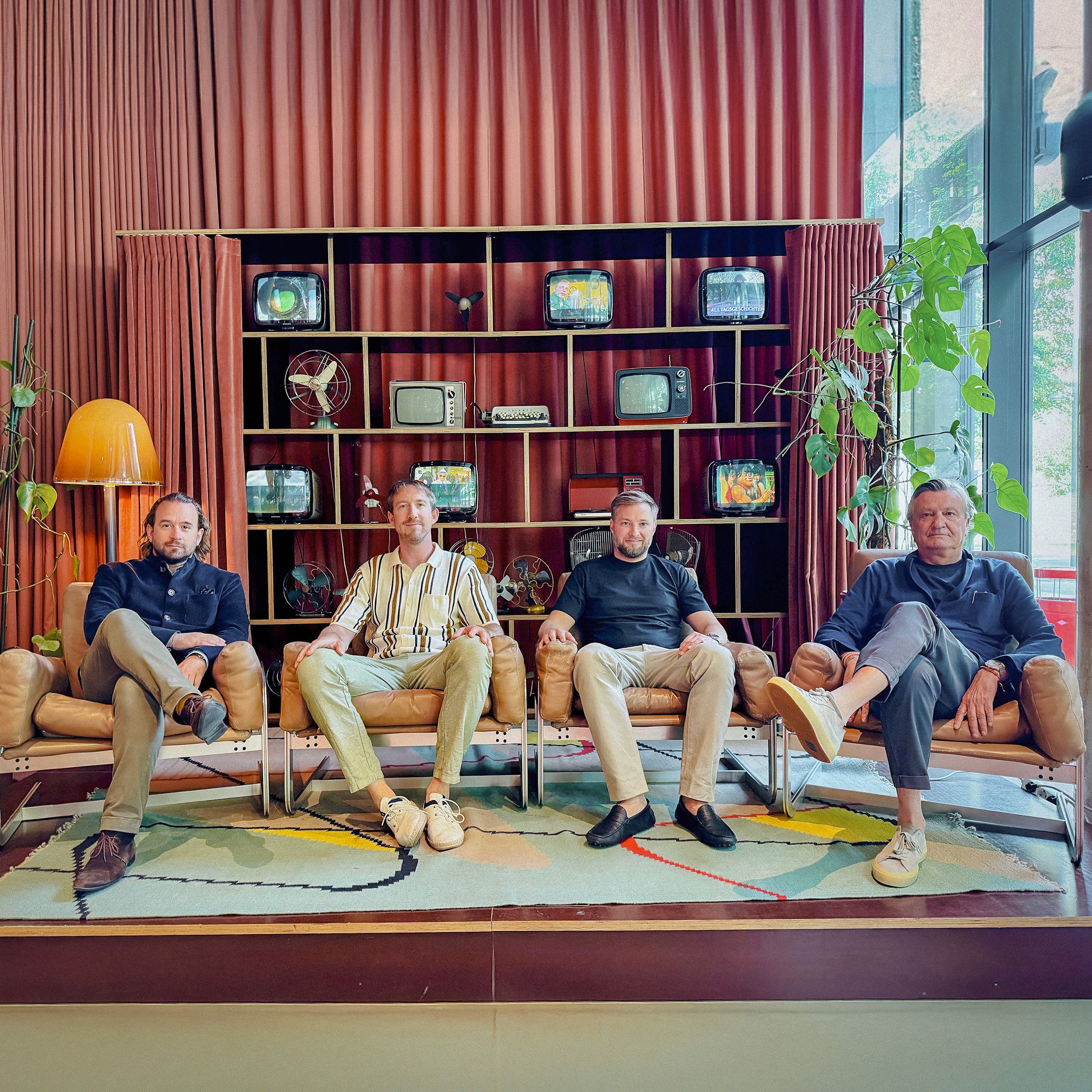 Photo of the four founders of The Companion Hotel sitting in lounge chairs.