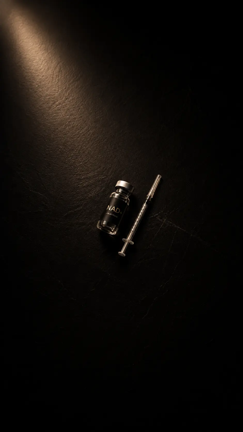 Image of NAD+ vial next to a syringe.
