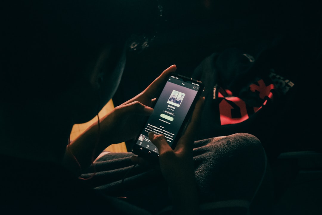 a person holding a cell phone in their hand