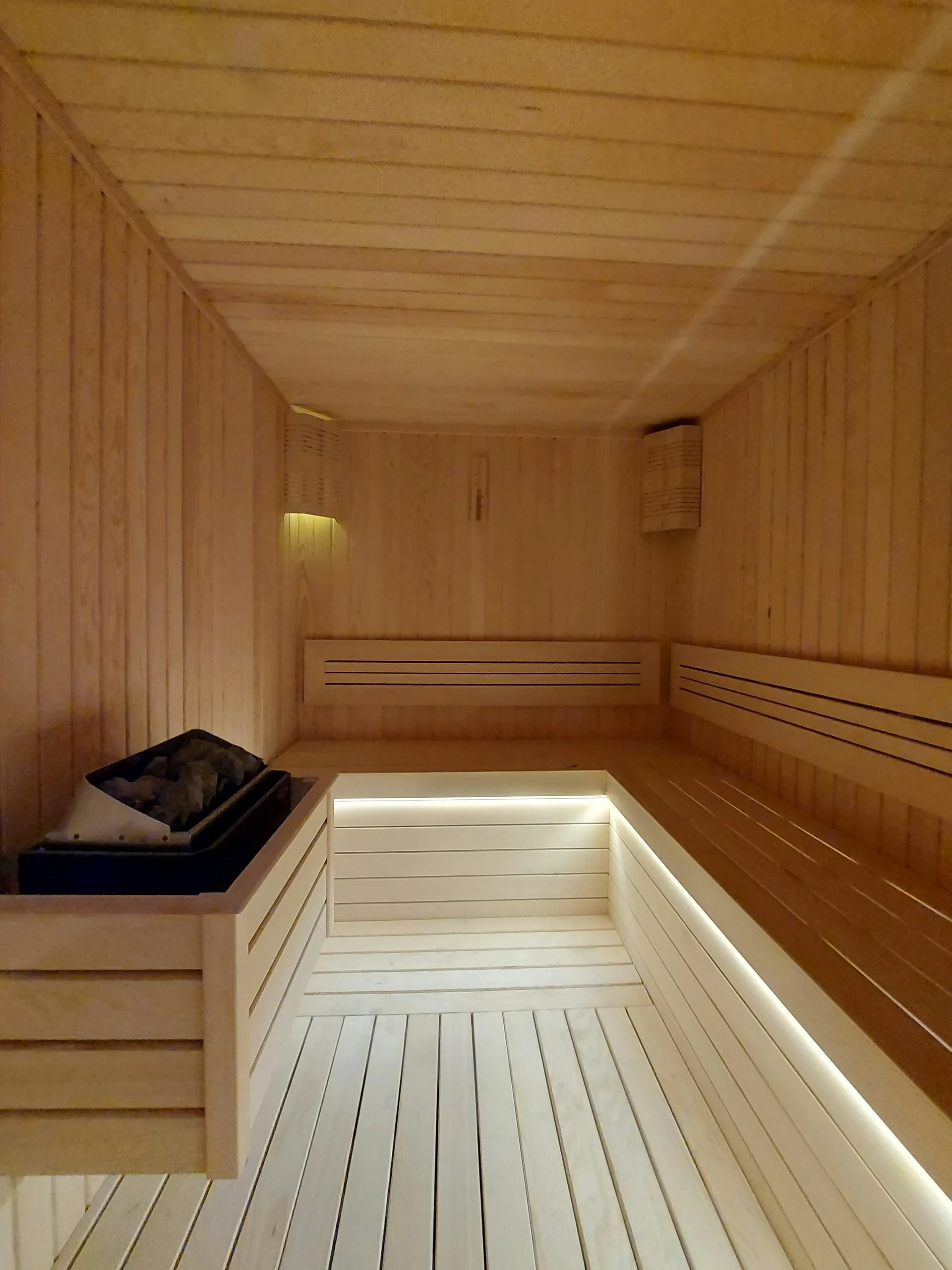 Sauna interior with lit wooden benches
