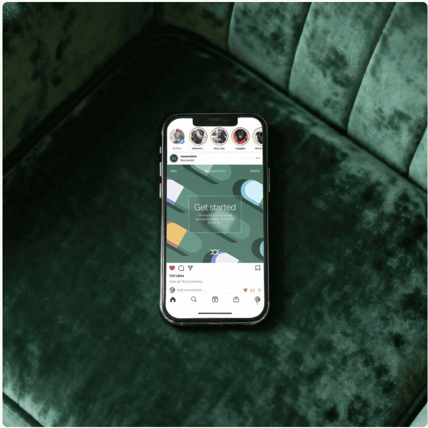 A smiling young man with crossed arms, wearing a plaid shirt and white t-shirt, poses against a dark background.