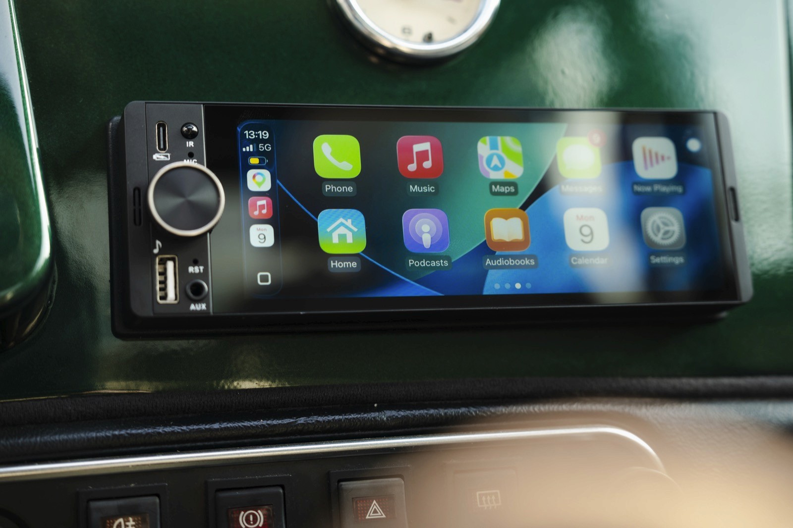 A smartphone is displayed on a surface, showcasing its app-filled screen against a dark background.