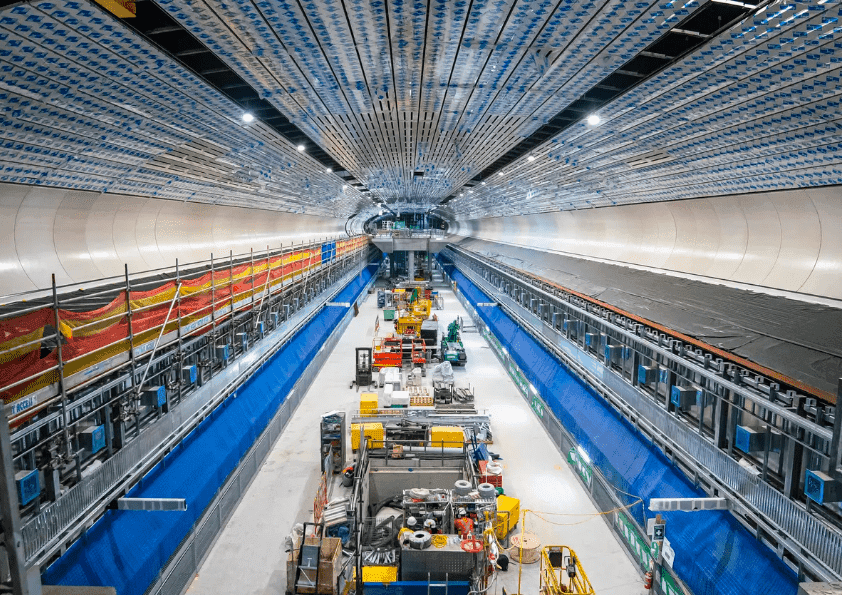 Tunnel construction with blue tarps and scaffolding